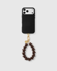 Rated 4.9 stars — full phone view with the cocoa star bead strap attached, showing wristlet drop and gold hardware