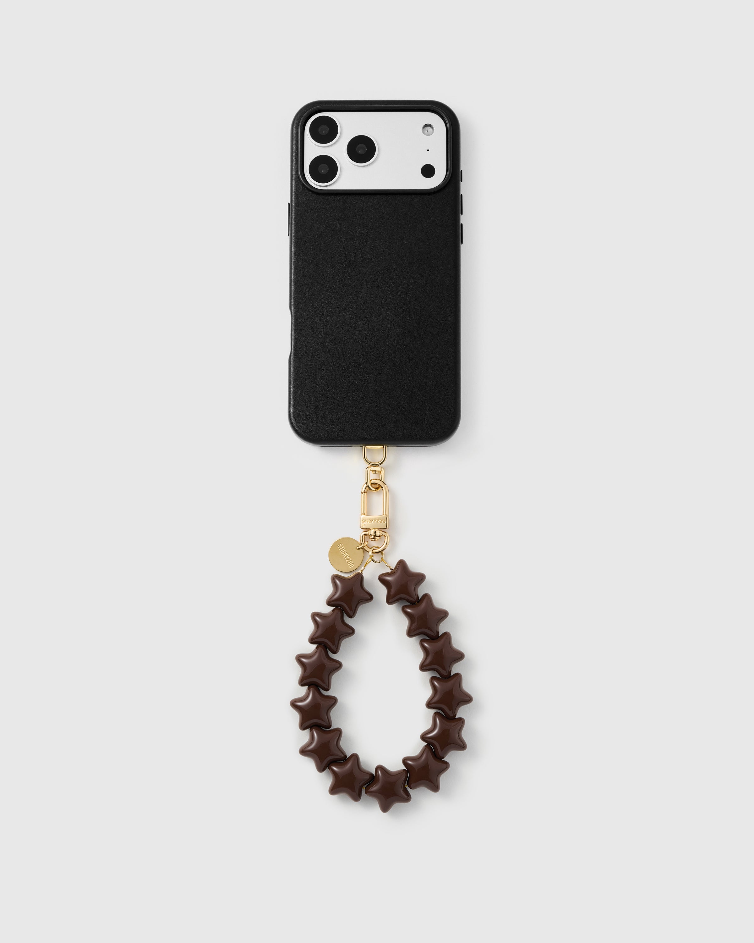 Rated 4.9 stars — full phone view with the cocoa star bead strap attached, showing wristlet drop and gold hardware