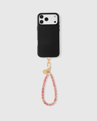 Full phone with rose stone wrist strap attached on light grey background