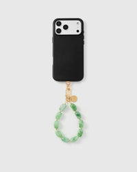 Full phone with jade marble stone strap attached on grey background