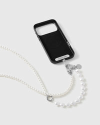 Black phone case marked STICKYZOO with the pearl-and-heart strap clipped on, silver-tone clasp, disc charm and O-ring visible.