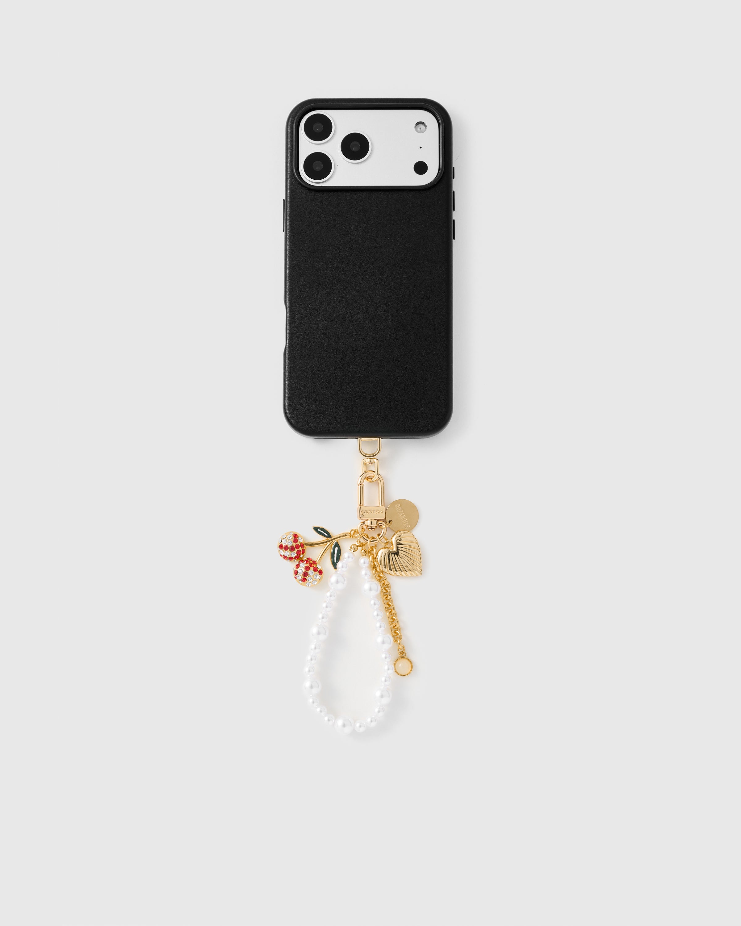 {{Works with any case}} Full phone with pearl orbit cherry charm strap attached on light grey background