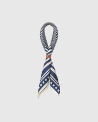 STICKYZOO optical stripe silk scarf threaded through a leather ring showing the chevron pattern wrapping the fold