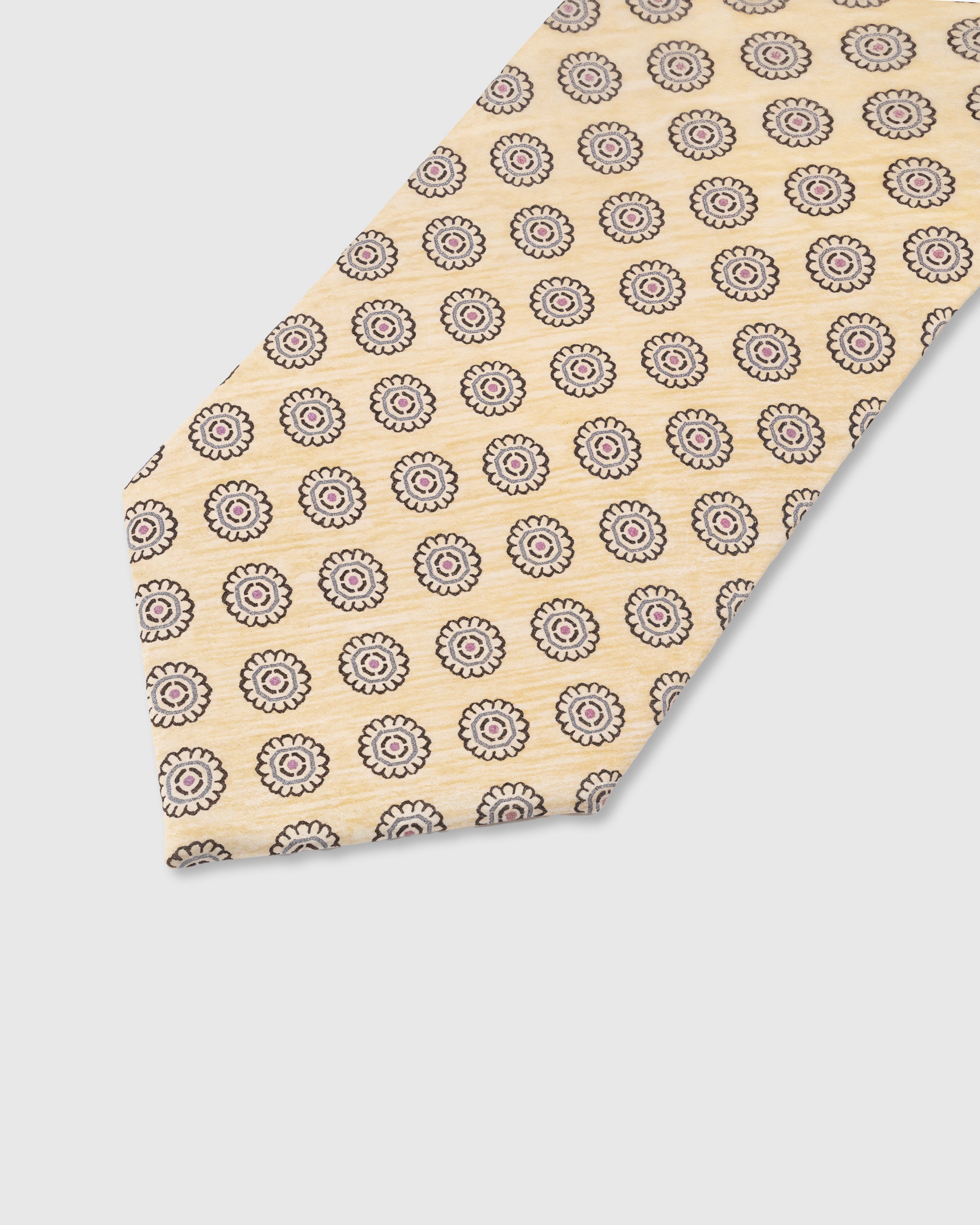 Walnut medallion circle detail on champagne mulberry silk tie showing raised hand-embroidered motif by STICKYZOO