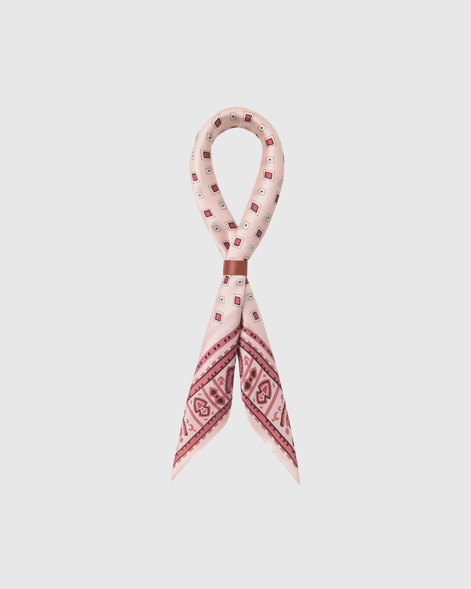 STICKYZOO rosewater tile silk scarf looped through a leather slide showing the pink tile border