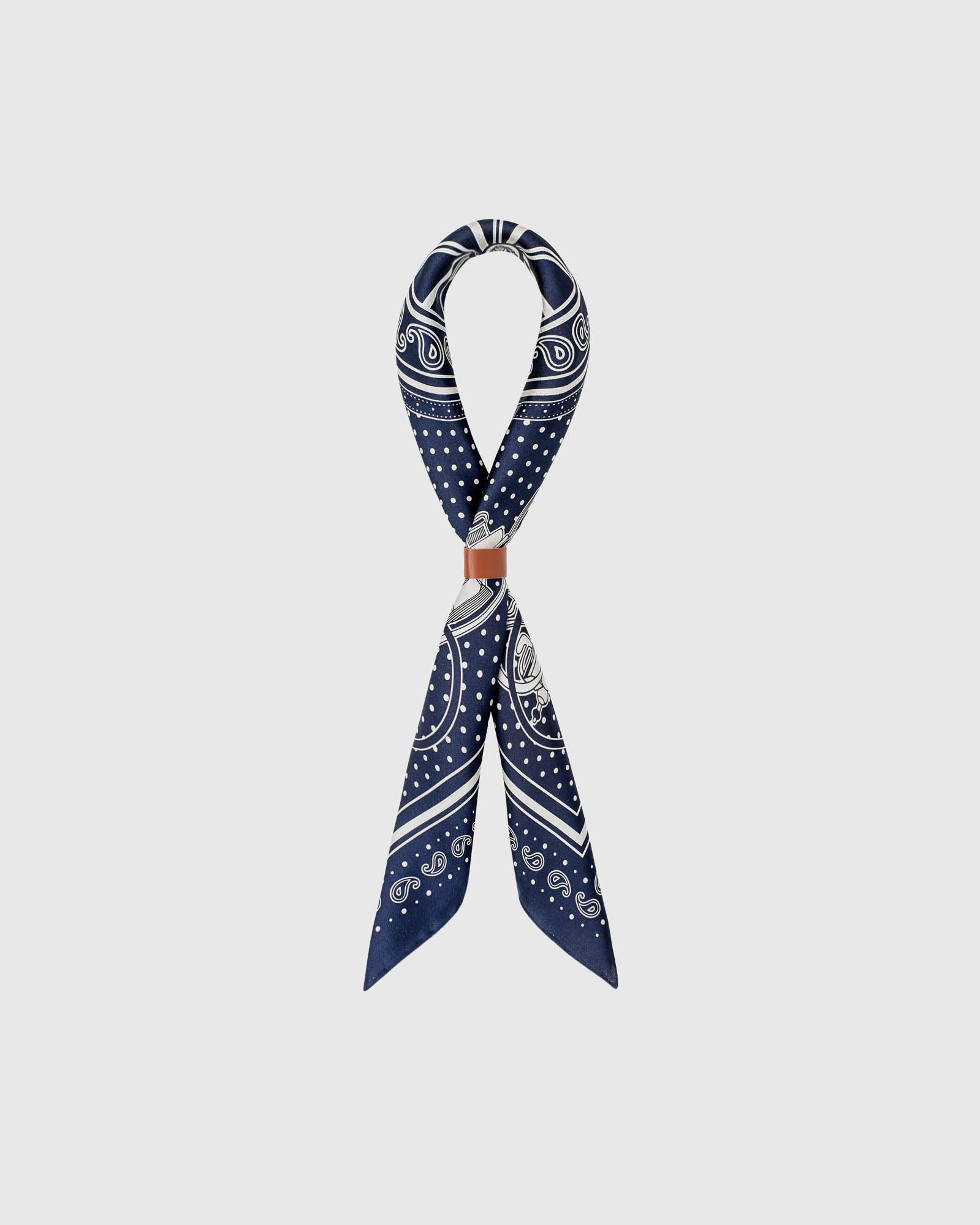 Pure silk bandana scarf folded to show the soft hand and the ivory bandana details on navy