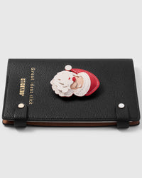 French Alran leather noël santa charm detail showing hand-cut and hand-stitched layers with engraved gold-plated hardware