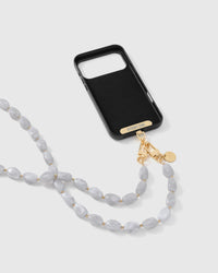 Full phone with cloud marble strap draped alongside on neutral background