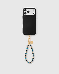 Obsidian azure orbit phone strap hanging from black phone case showing wrist carry