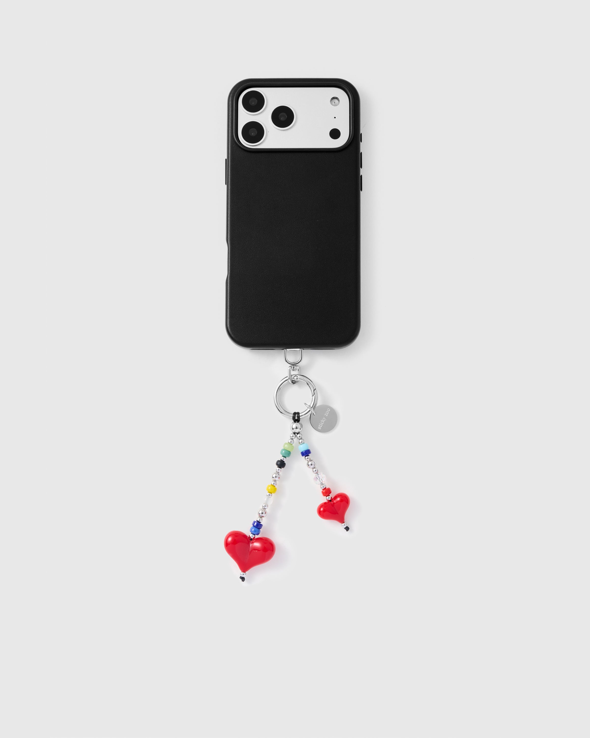 Full phone with double heart dangle strap attached showing universal compatibility
