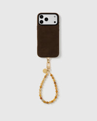 Full phone paired with the honey-toned real stone bead wrist strap in a clean studio setting