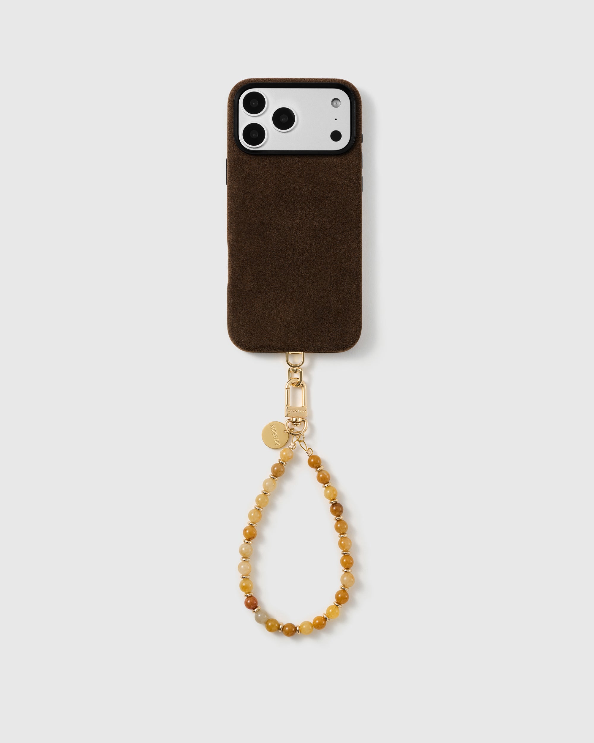 Full phone paired with the honey-toned real stone bead wrist strap in a clean studio setting