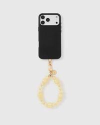 Full phone with lemon glow strap attached on light grey background