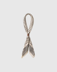 STICKYZOO horseshoe luck silk scarf looped and gathered with a slide showing the scattered horseshoe motif