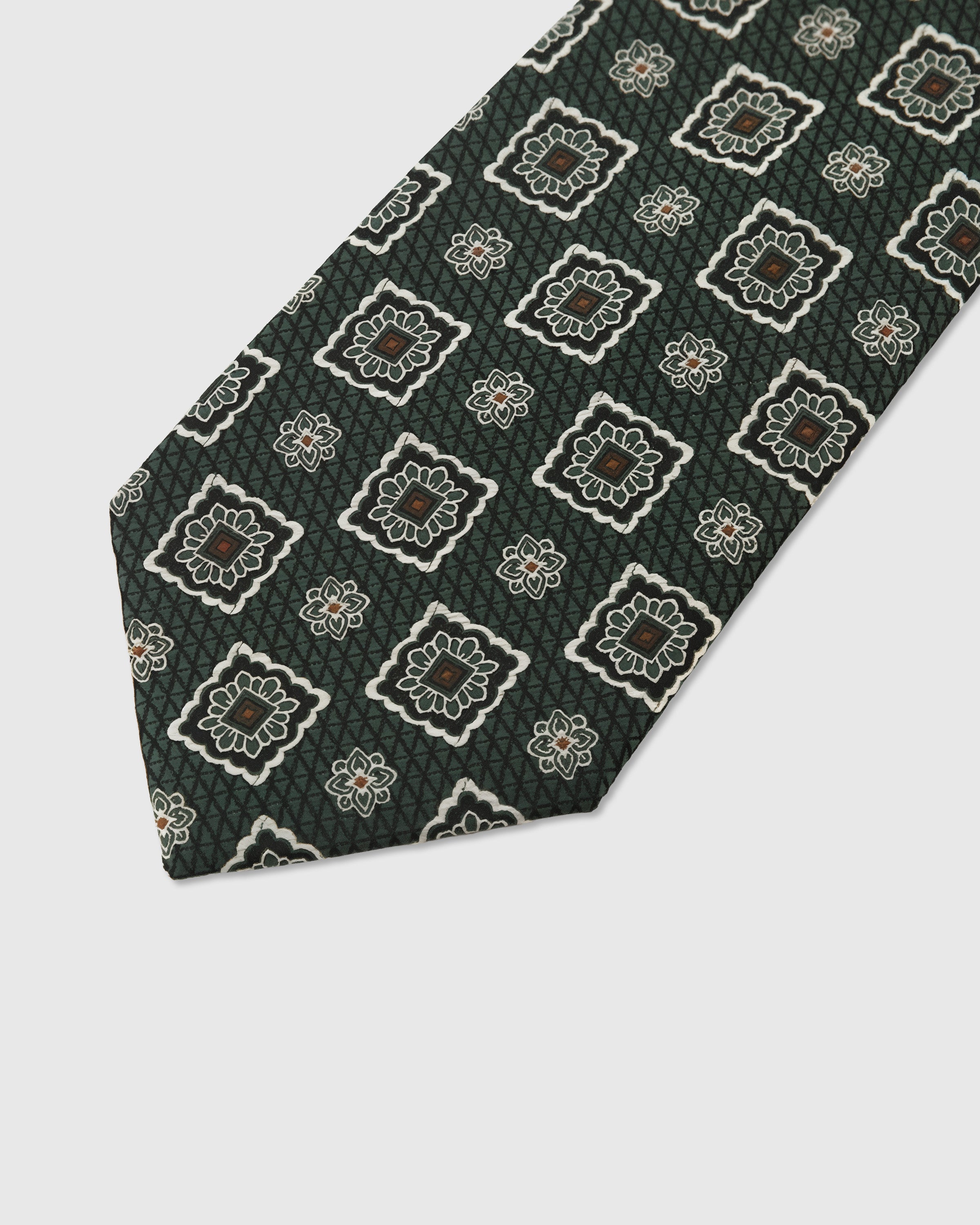 Ornate medallion detail on evergreen mulberry silk tie showing multi-color hand-embroidered motif by STICKYZOO