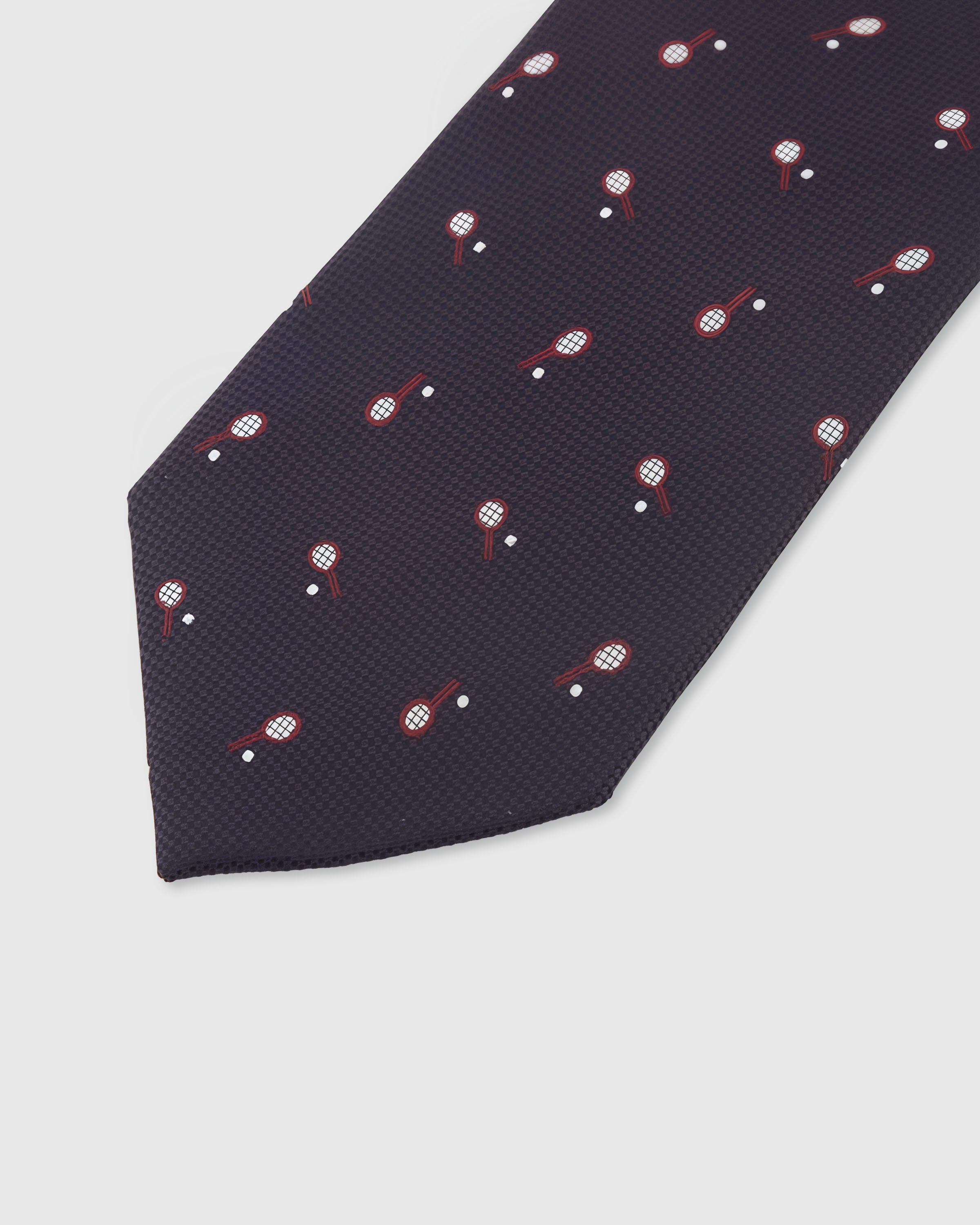PLUM RACQUET TIE — 45° Italian bias-cut construction with structured interlining, hand-finished slip stitching visible on interior