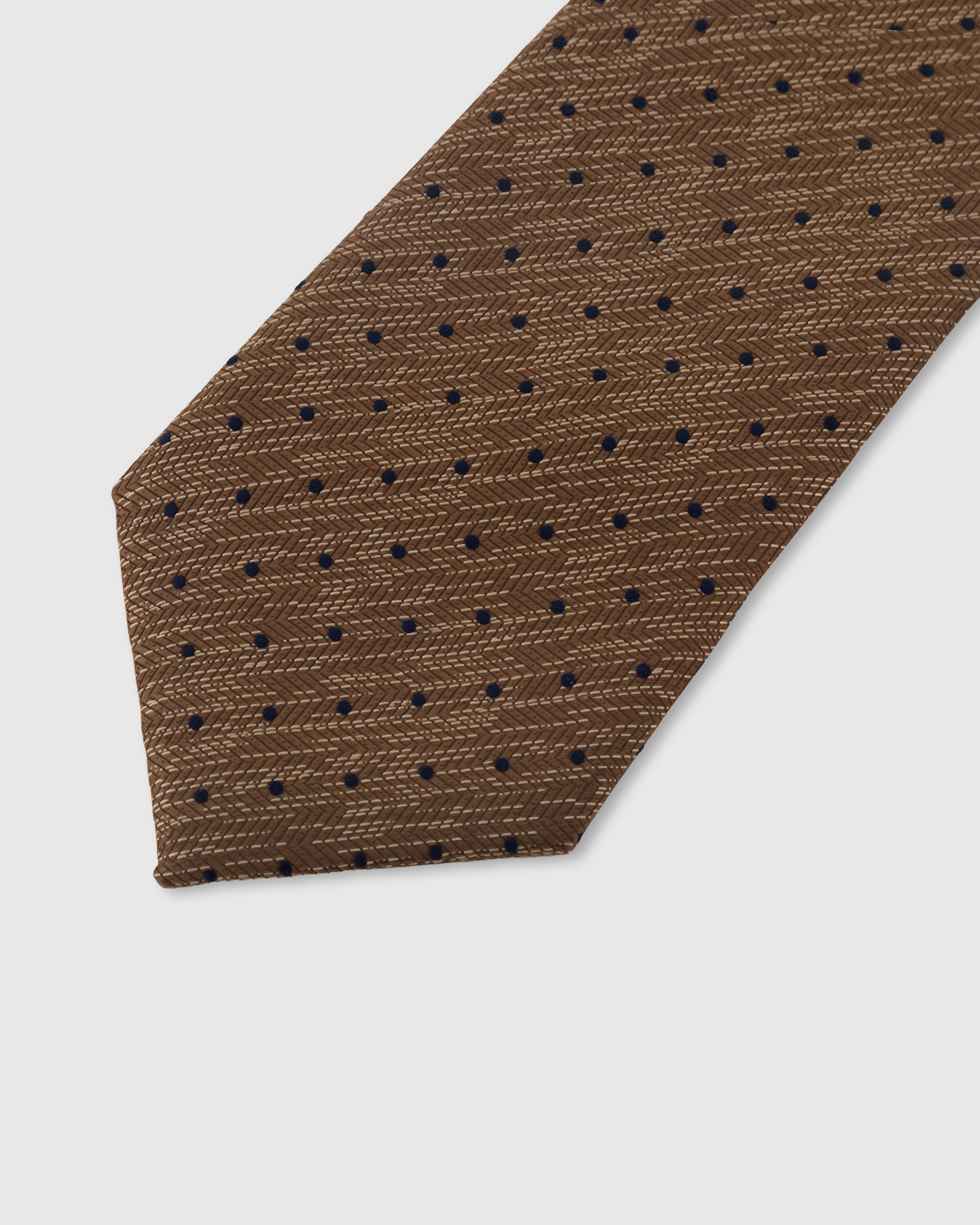 Navy pin dot detail on caramel mulberry silk tie showing raised hand-embroidered thread on woven-texture ground by STICKYZOO