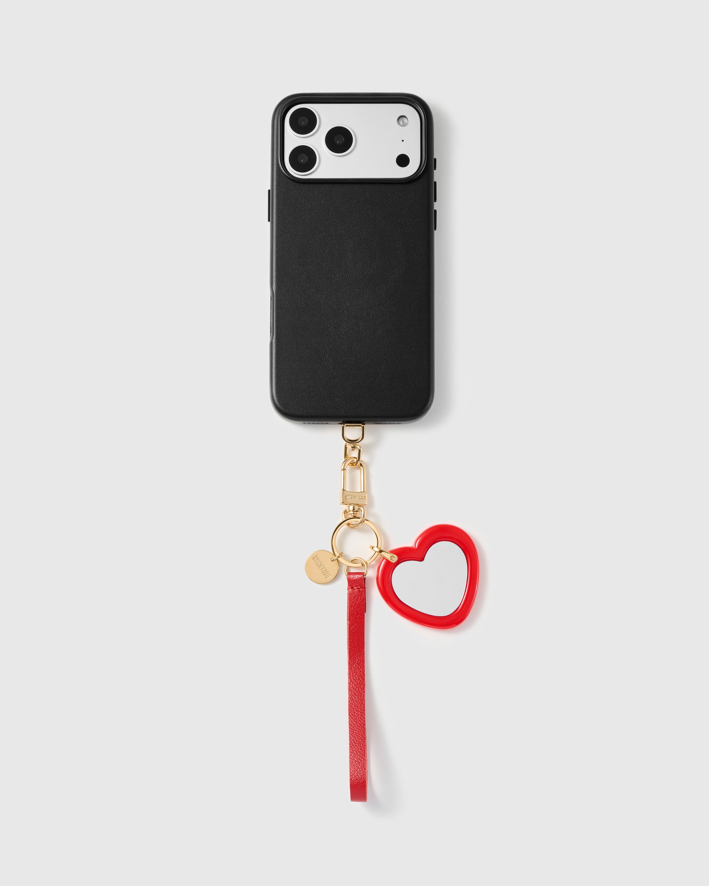 Close-up of red heart pocket mirror showing real glass set in hand-cut glossy red acetate frame