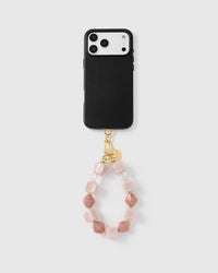 Full phone with rose marble bead strap attached on grey background