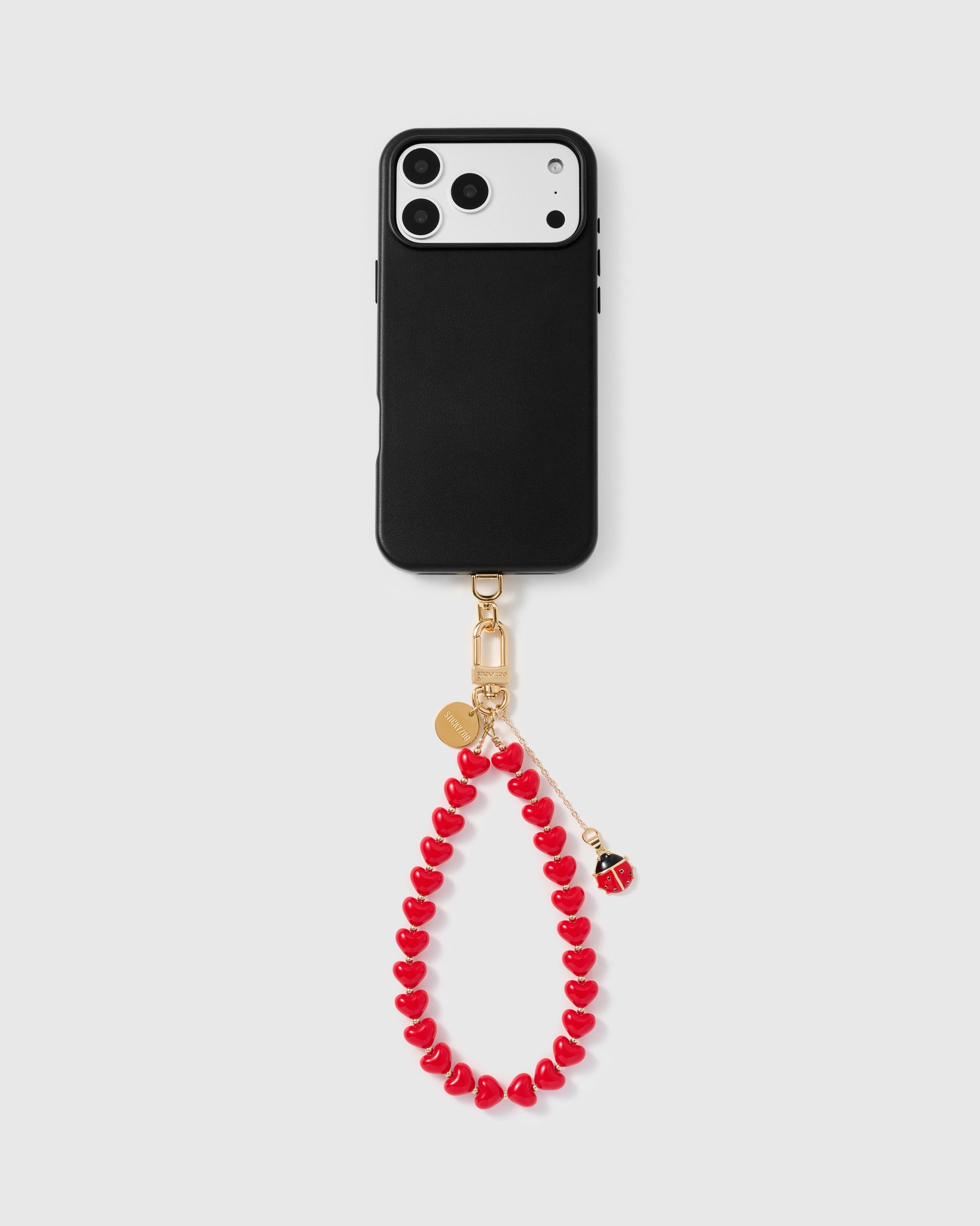 Full phone with ladybug heart strap attached — Rated 4.9 stars by Mia C.