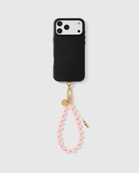 Pale pink heart phone strap worn as a wrist loop with phone case for hands-free carry