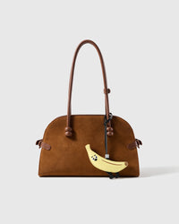 STICKYZOO leather banana charm shown hanging on a handbag, French Alran goatskin, handmade over three days