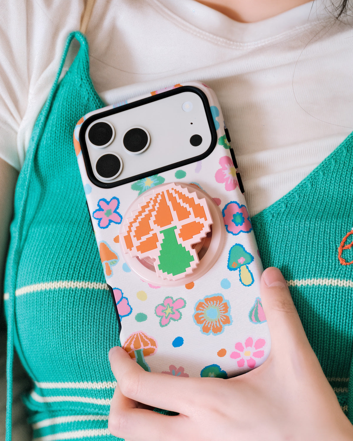 STICKYZOO pixel mushroom phone case with a 3D pixel mushroom embedded inside the pink acrylic-resin grip