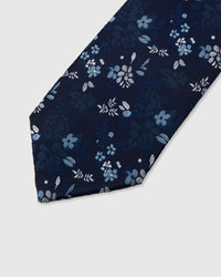 STICKYZOO MIDNIGHT BLOSSOM TIE — hand-embroidered detail showing scattered pale blue and silver blossoms with foliage, stitched not printed