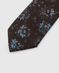 Blue floral cluster detail on espresso mulberry silk tie showing hand-embroidered petal work by STICKYZOO