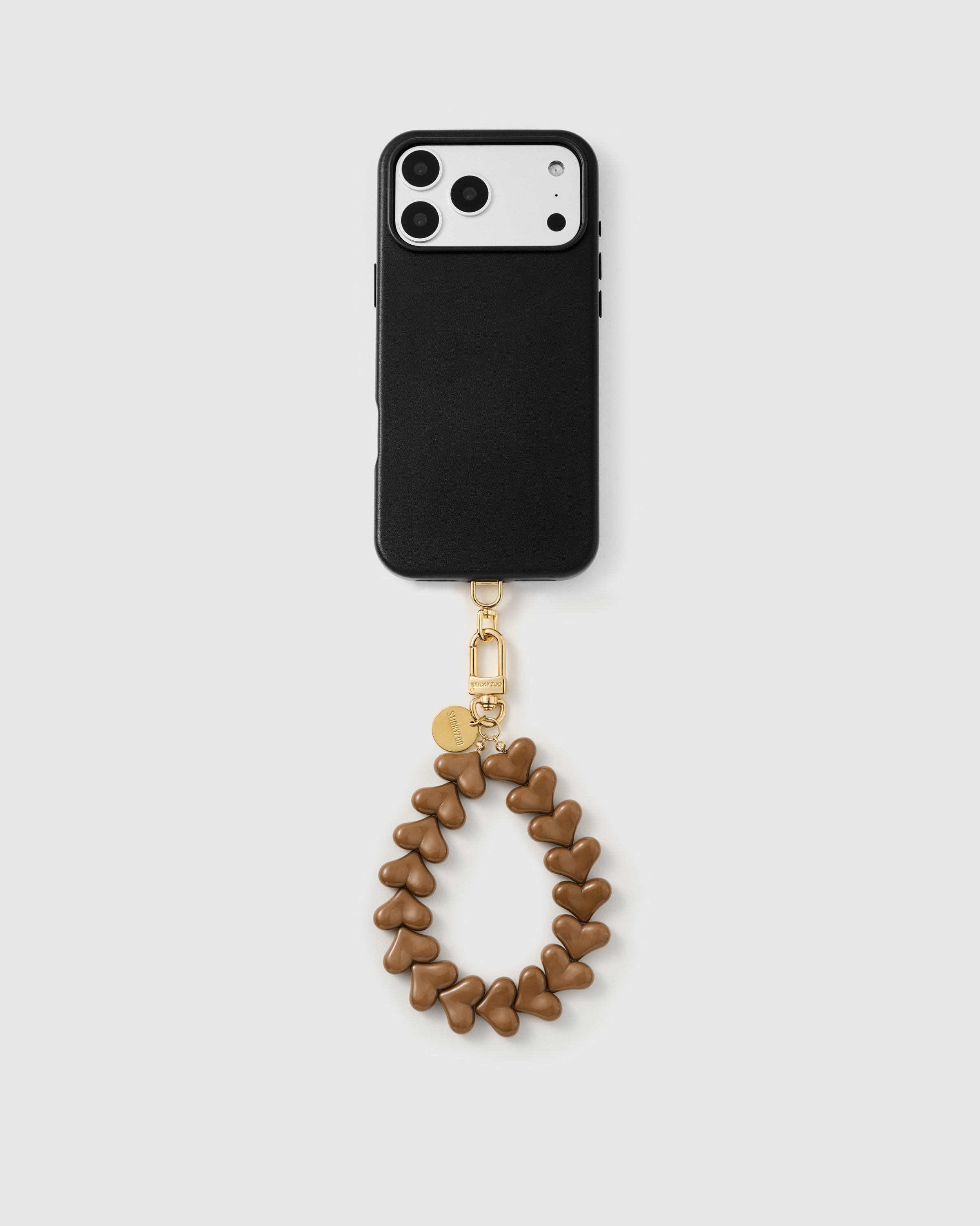 Full phone with caramel heart wristlet attached on neutral background — Rated 4.9 stars