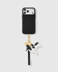Leather dog charm phone strap clipped to a phone case, worn hands-free from the wrist