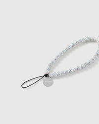 Close-up of the black stretch-cord loop and engraved silver STICKYZOO disc, with iridescent glitter beads catching the light.