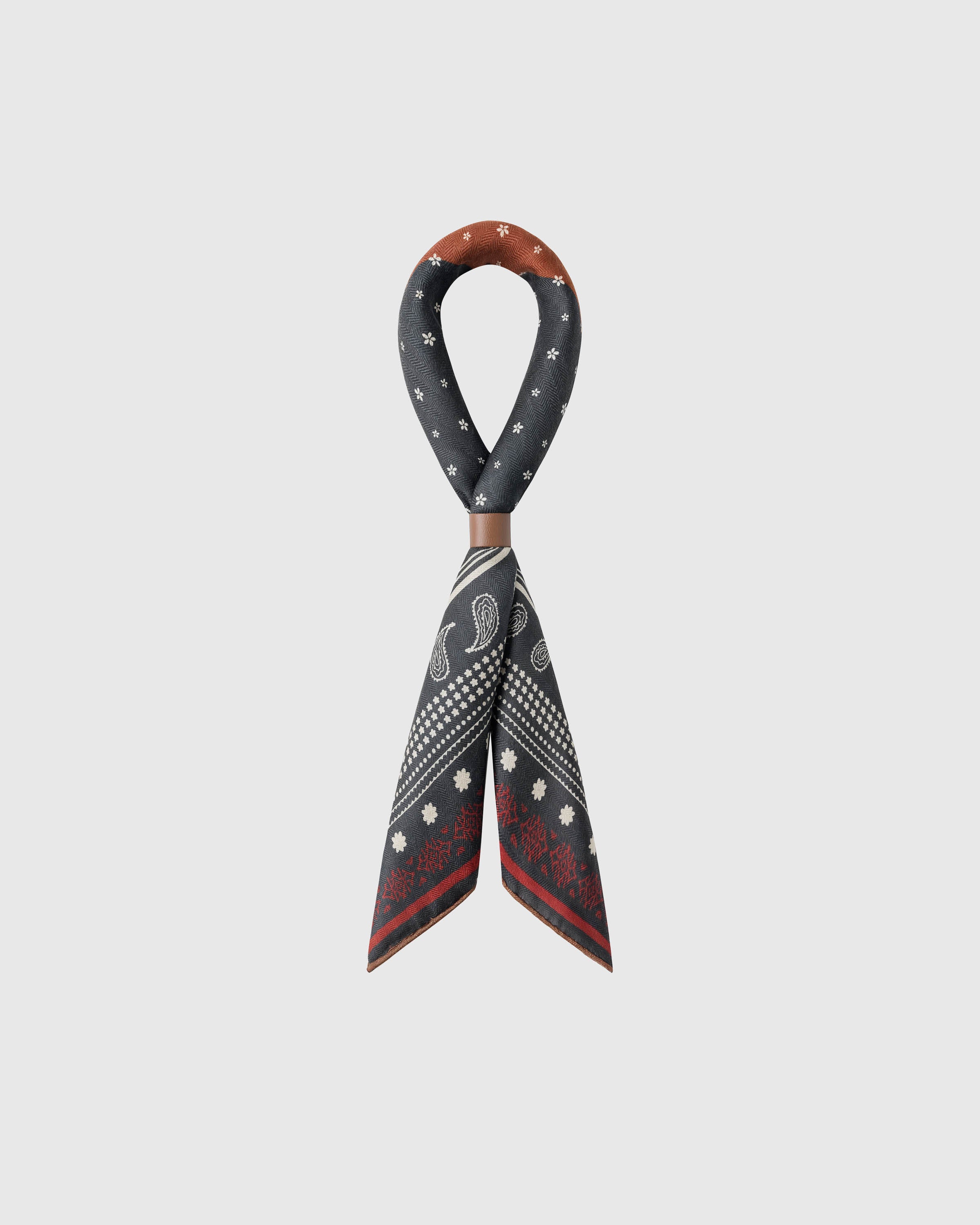 STICKYZOO bandana silk scarf looped through a leather slide showing the paisley border drape