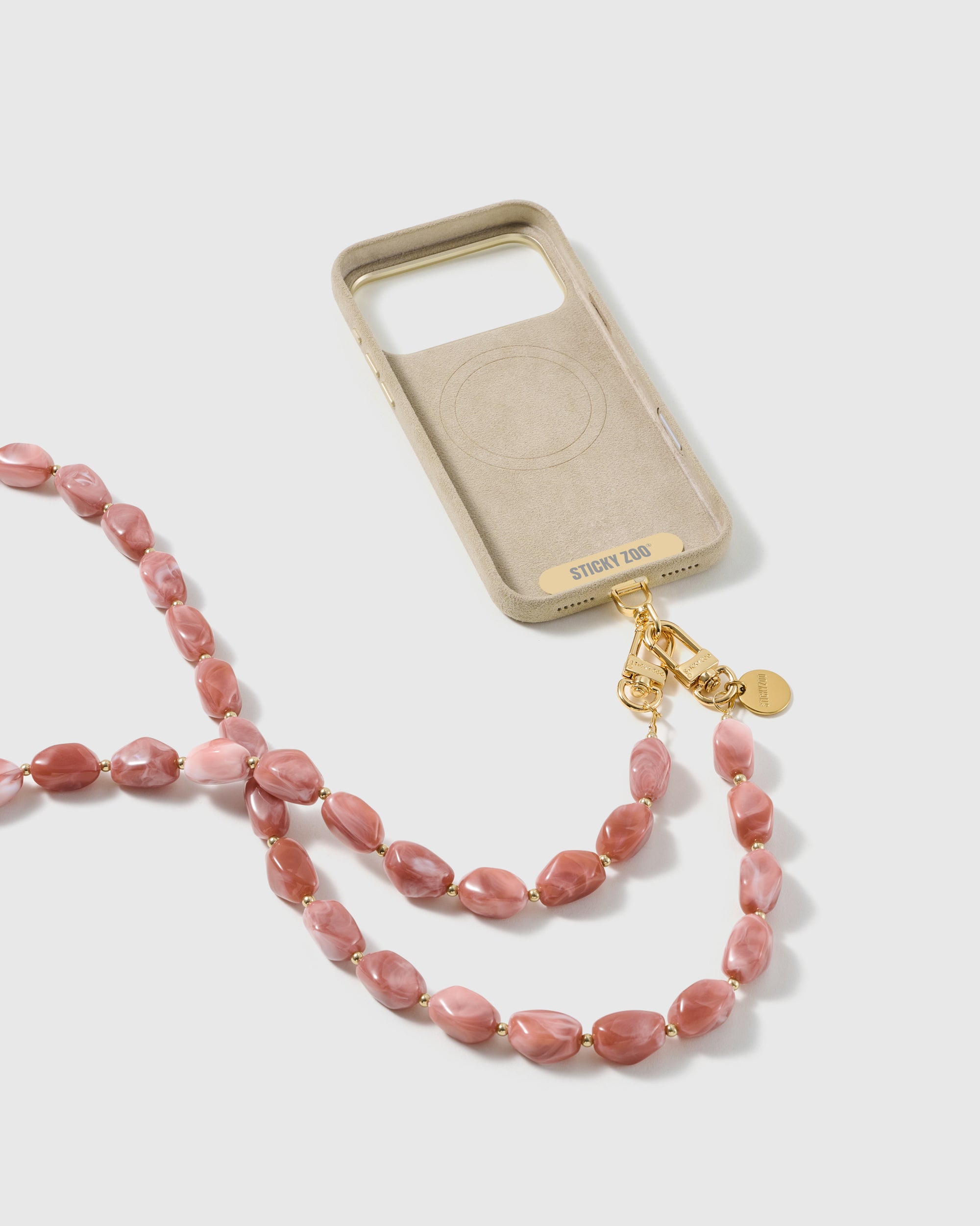 STICKYZOO blush resin cross-body strap on a full phone in studio light, kept by 99 percent of buyers