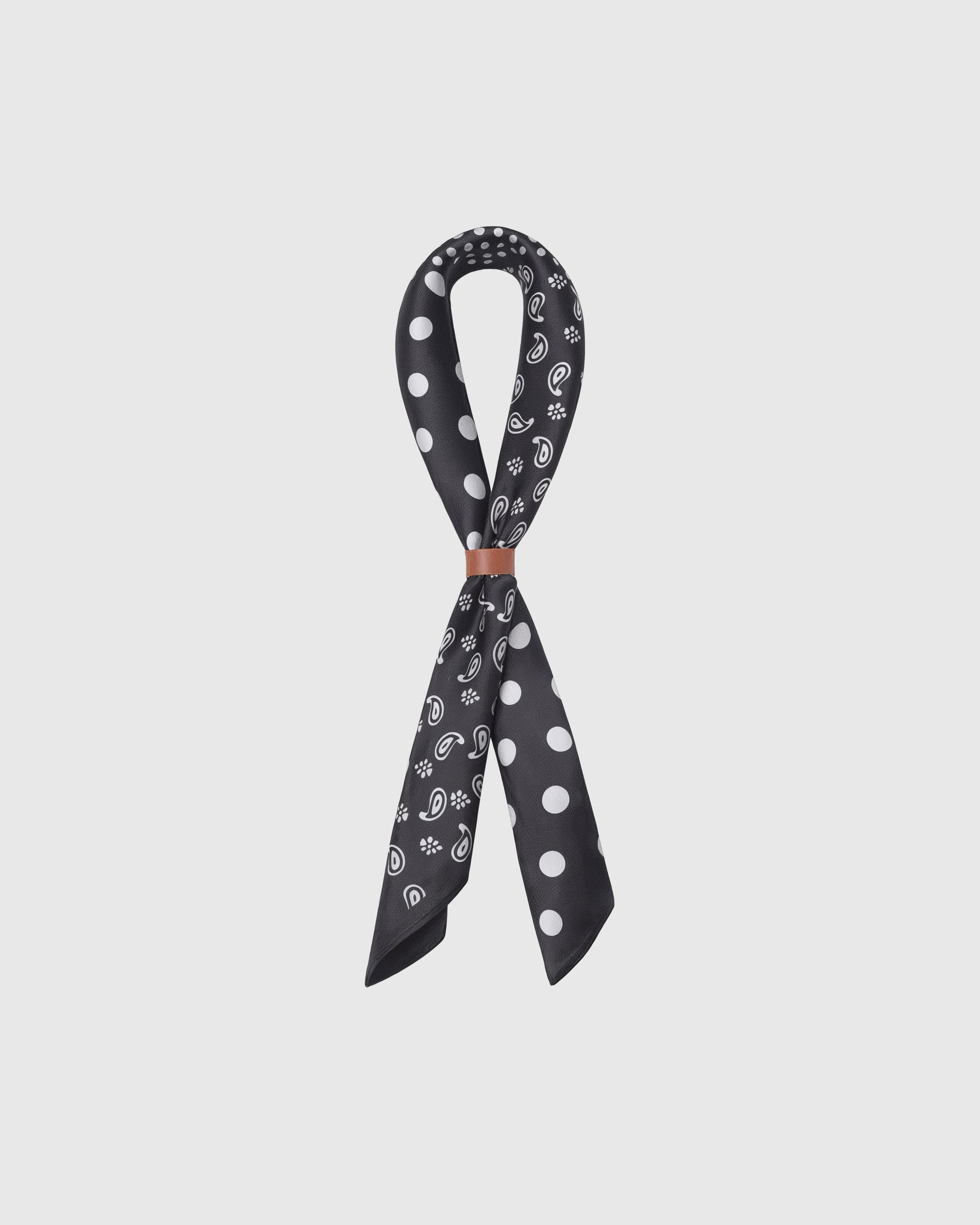 STICKYZOO monochrome silk scarf knotted through a leather slide showing the paisley and polka quadrants