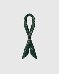 STICKYZOO emerald silk scarf folded long through a leather ring showing the micro-paisley motif