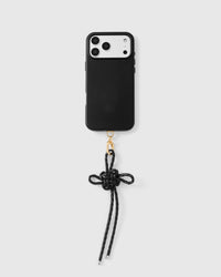 Black leather bow strap attached to black phone case showing full pairing