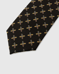 STICKYZOO ONYX PETAL TIE — hand-embroidered detail showing gold and russet four-petal leaf motifs, stitched not printed