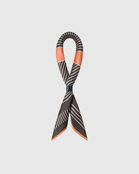 Close-up of the terracotta border meeting the ivory stripes on pure silk in archival inks