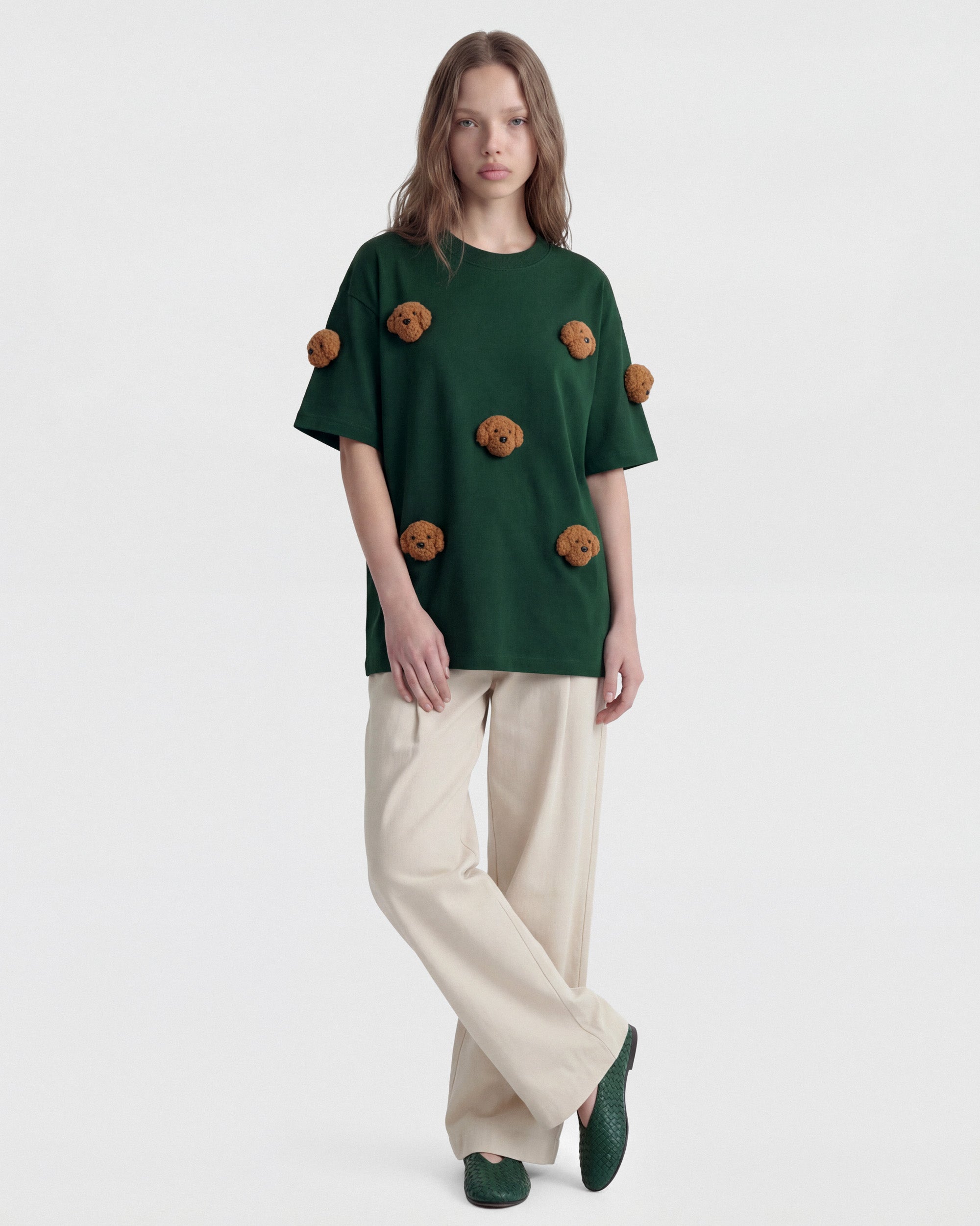 {{Model is wearing size M}} Model wearing STICKYZOO green Poodle Parade T-Shirt showing dropped shoulders and plush poodles