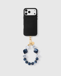 Full phone with sapphire marble cluster strap attached on grey background