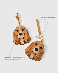 Cocker Spaniel leather bag charm shown in both attachment options — leather strap with engraved 18K gold cube and keychain clip with engraved gold tag. Handmade by STICKYZOO from French Alran leather and suede.