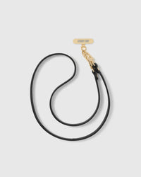 Black vegan-leather cross-body phone strap shown in full with stitched edging, twin connectors and 18K gold-plated STICKYZOO hardware