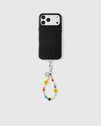 Full phone with smiley face rainbow wrist strap attached on light background