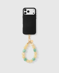 Full phone with butter jade orbit strap attached on light grey background