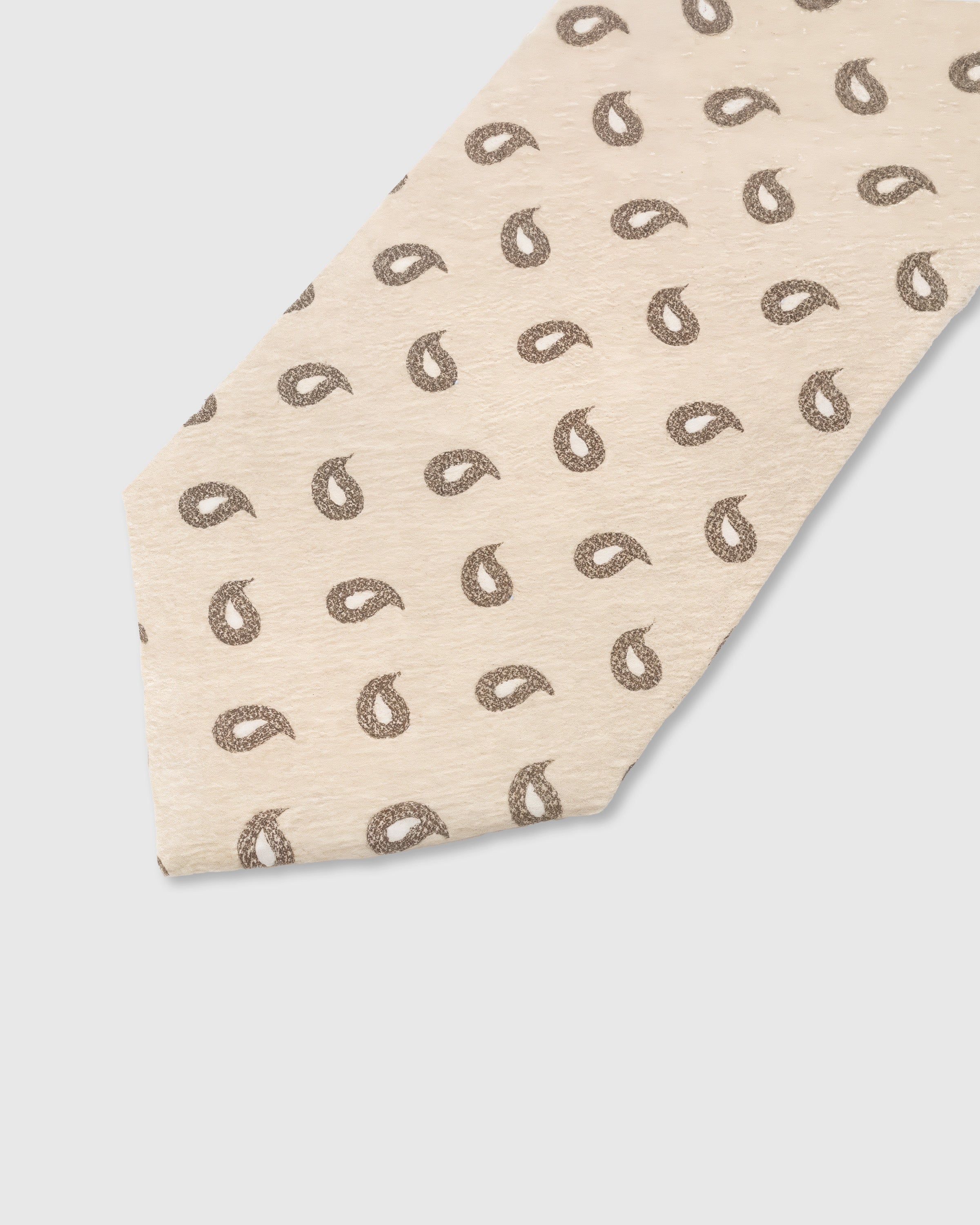 Walnut paisley drop detail on sand mulberry silk tie showing raised hand-embroidered motif by STICKYZOO