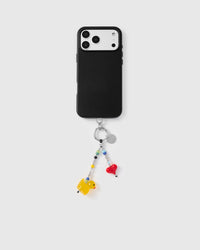 Full phone with tangerine duck heart strap attached on grey background