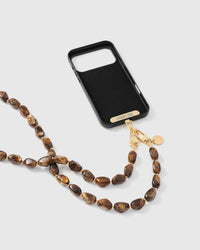Full phone with amber smoke link strap draped alongside on grey background