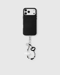 Full phone with black and white pixel heart wrist strap attached on light background