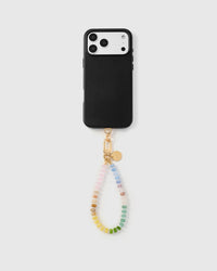 Phone with rainbow agate orbit strap attached on light background